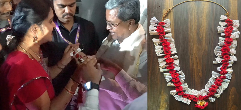 Karnataka CM Siddaramaiah receives a garland made of free bus tickets